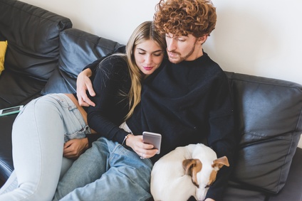 Young couple in love using smart phone