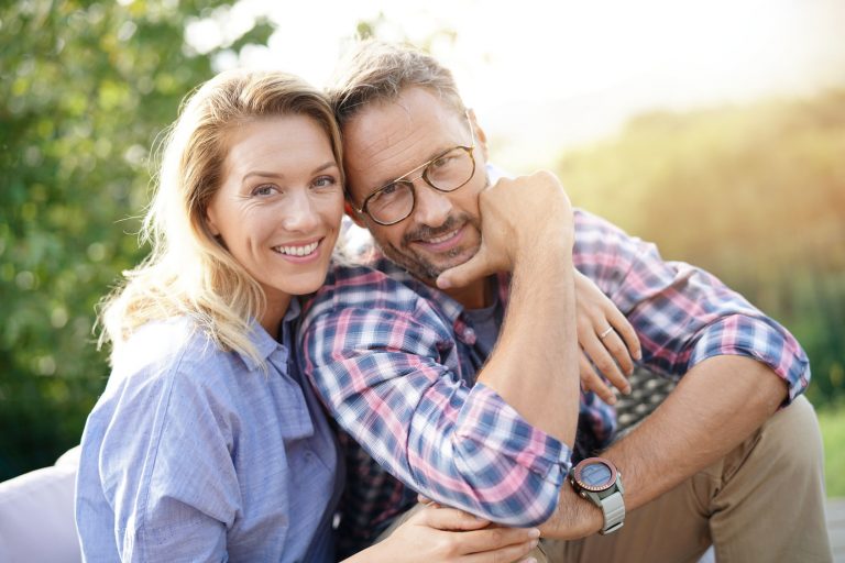 Portrait of mature couple relaxing in outdoor sofa